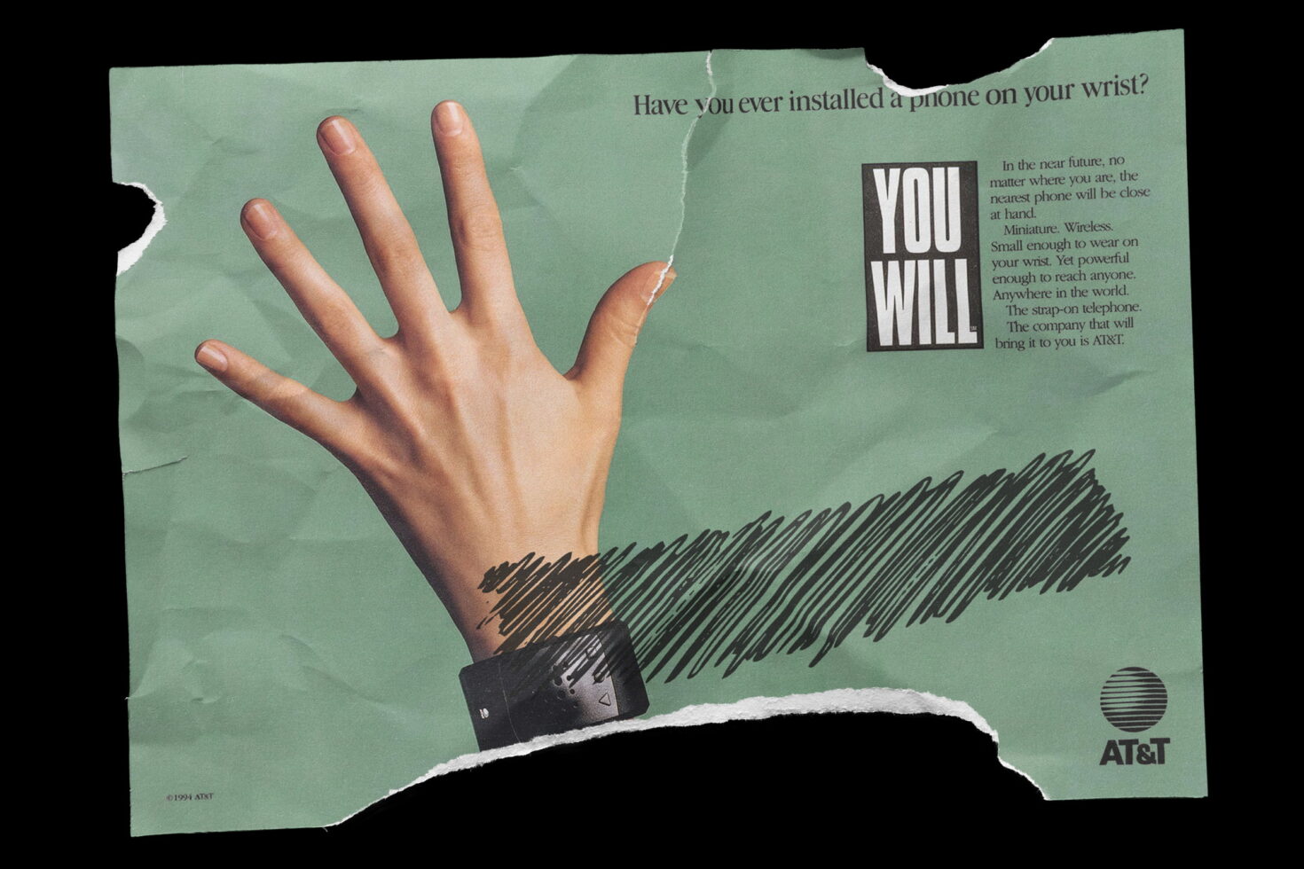 Vintage mint green AT&T advertisement showing hand wearing wrist phone with torn edges
