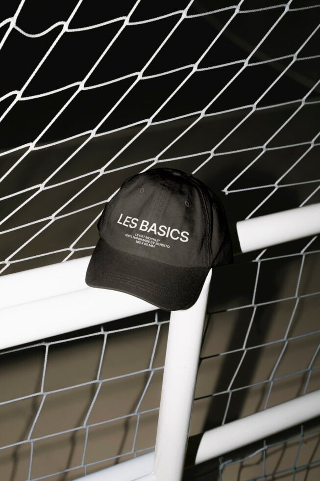 Black baseball cap mockup on a fence with customizable logo design. Perfect for graphic designers creating promotional or branding materials Templates