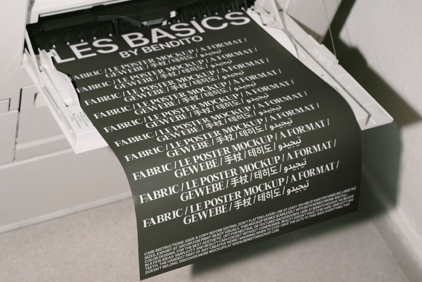 Close-up of dark fabric poster mockup in printer tray with multilingual text