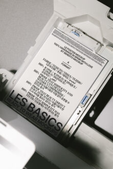 Light poster mockup inside white organizer box showing Les Basics Ready To Wear