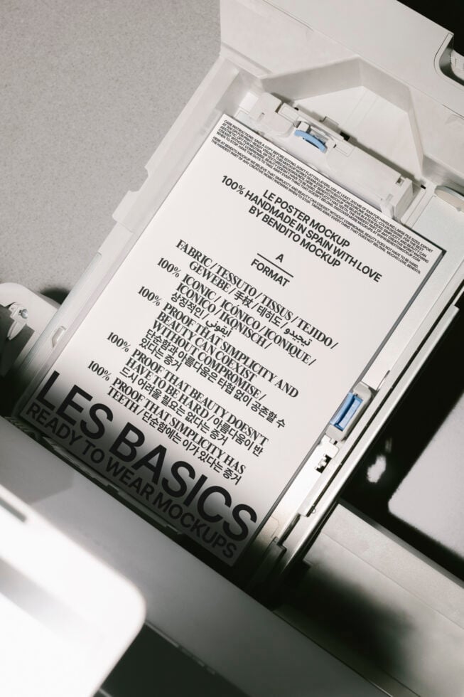 Poster mockup featuring multilingual text in a printer tray. Keywords: mockup, poster, design, template, typography. Perfect for graphic designers.