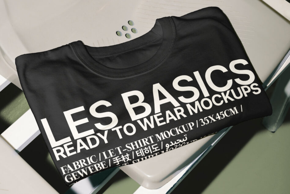 Black folded t-shirt mockup displaying Les Basics Ready To Wear text layout
