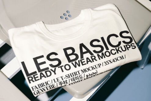 Folded white t-shirt with bold text LES BASICS ready to wear mockups suitable for apparel designers SEO keywords t-shirt mockup design template