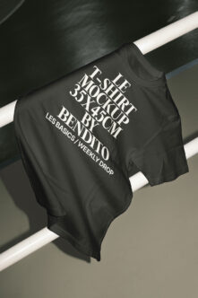 Black tee mockup draped on white pipes with layered typography design
