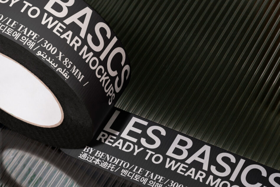 Rolled black fabric swatches with silver foil text showing wear mock-up specs on textured green background