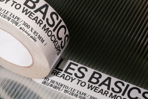 Mockup of adhesive tape roll with text Les Basics ready to wear on a textured surface ideal for designers graphic templates product presentation