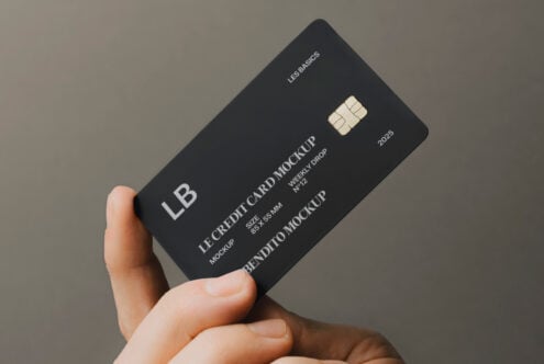 Hand holding a sleek black credit card mockup showcasing branding design, ideal for graphic designers seeking realistic templates for presentations.