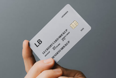 Credit card mockup held by hand, gray background; ideal for designers seeking realistic, high-quality mockups; useful for branding, presentations, visual assets.