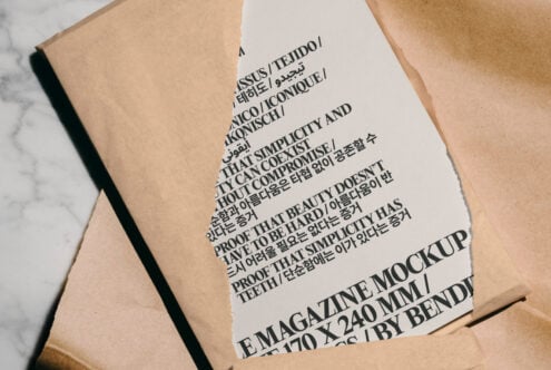 Magazine mockup on torn paper background showcasing multilingual typography. Ideal digital asset for designers seeking versatile, high-quality template resources.