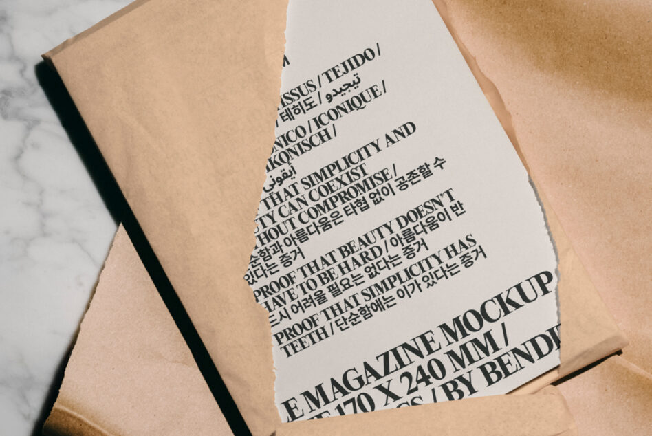 Magazine mockup on torn paper background showcasing multilingual typography. Ideal digital asset for designers seeking versatile, high-quality template resources.