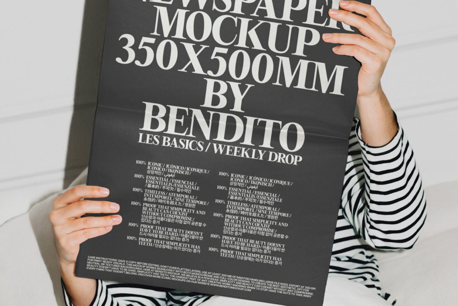 Hands holding dark newspaper mockup with multilingual text layout