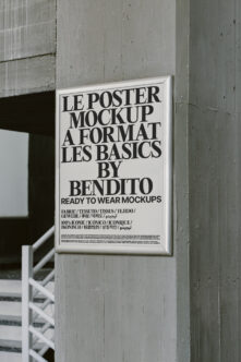 White framed poster mounted on industrial concrete wall with typography mockup design