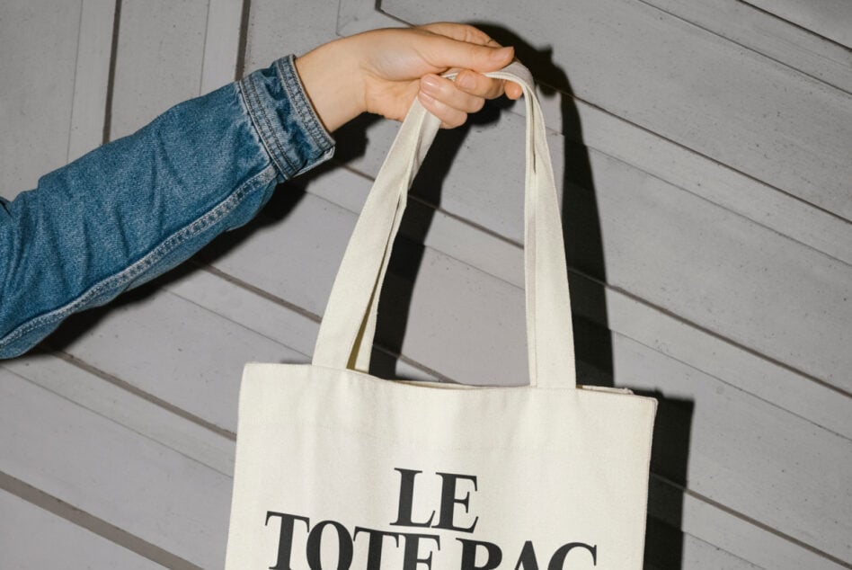 Natural linen tote bag handles close up with Le Tote Bag text on wooden backdrop