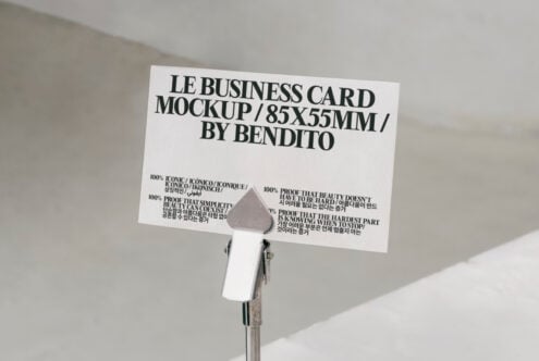 Business card mockup 85x55mm by Bendito displayed on clip stand. Minimalist and professional design, ideal for showcasing branding and identity templates.