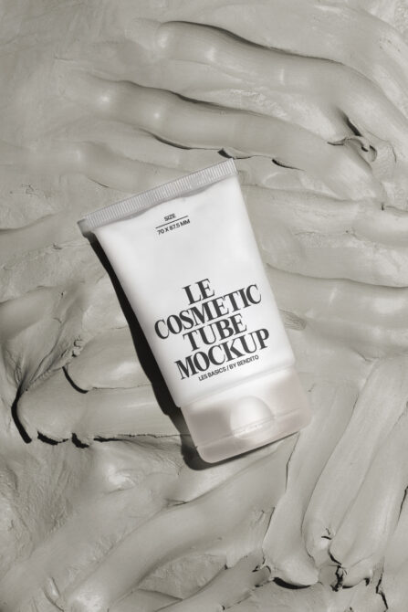 White cosmetic tube mockup on textured light gray cream background flat
