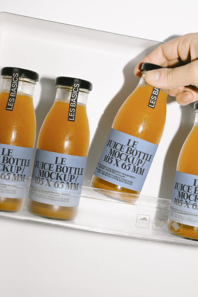 Juice bottle mockup with hand placing bottle. Perfect for design presentations or product showcase. Keywords mockup design template packaging.