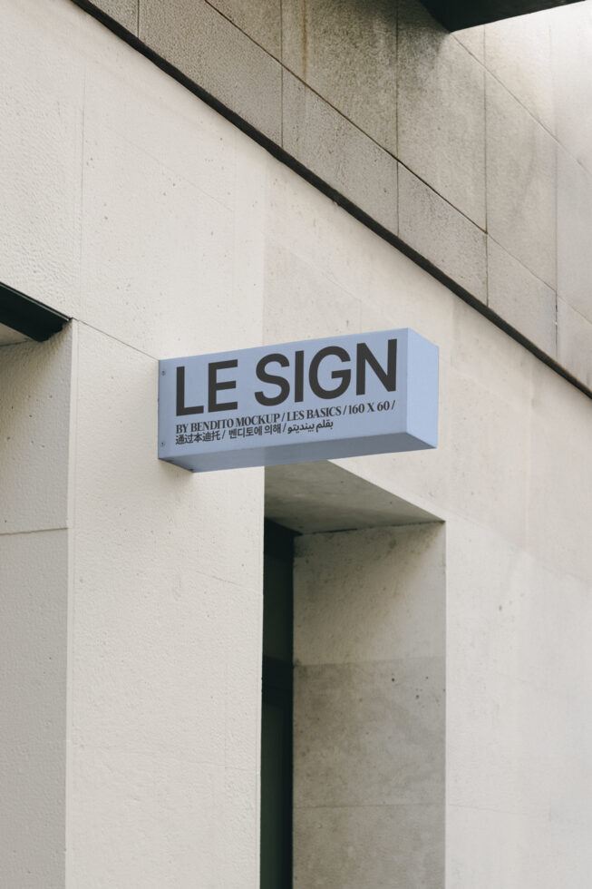 Outdoor wall-mounted shop sign mockup displayed on textured concrete building facade. Ideal for branding presentations and design templates.