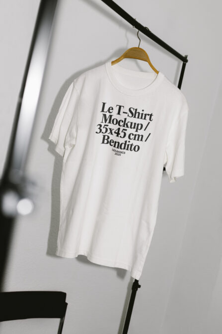 White t-shirt hanging showing centered text layout mockup