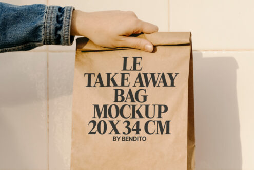 Paper bag mockup with hand holding a 20x34 cm design ideal for showcasing branding and packaging concepts. Perfect for designers and product promotions.