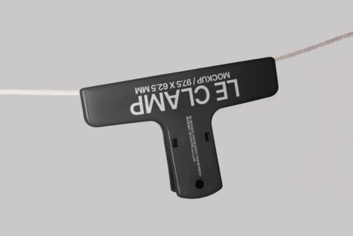 Gray plastic clamp mockup with text Mockup 97.5 x 62.5 mm on surface isolated on a light background perfect for designers product display.