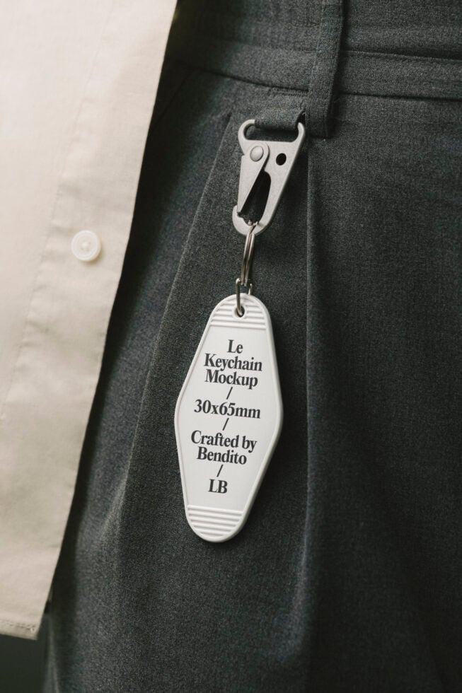 Keychain mockup hanging on dark pants with metal clip text label for design crafted by Bendito in 30x65mm size ideal for graphic designers.
