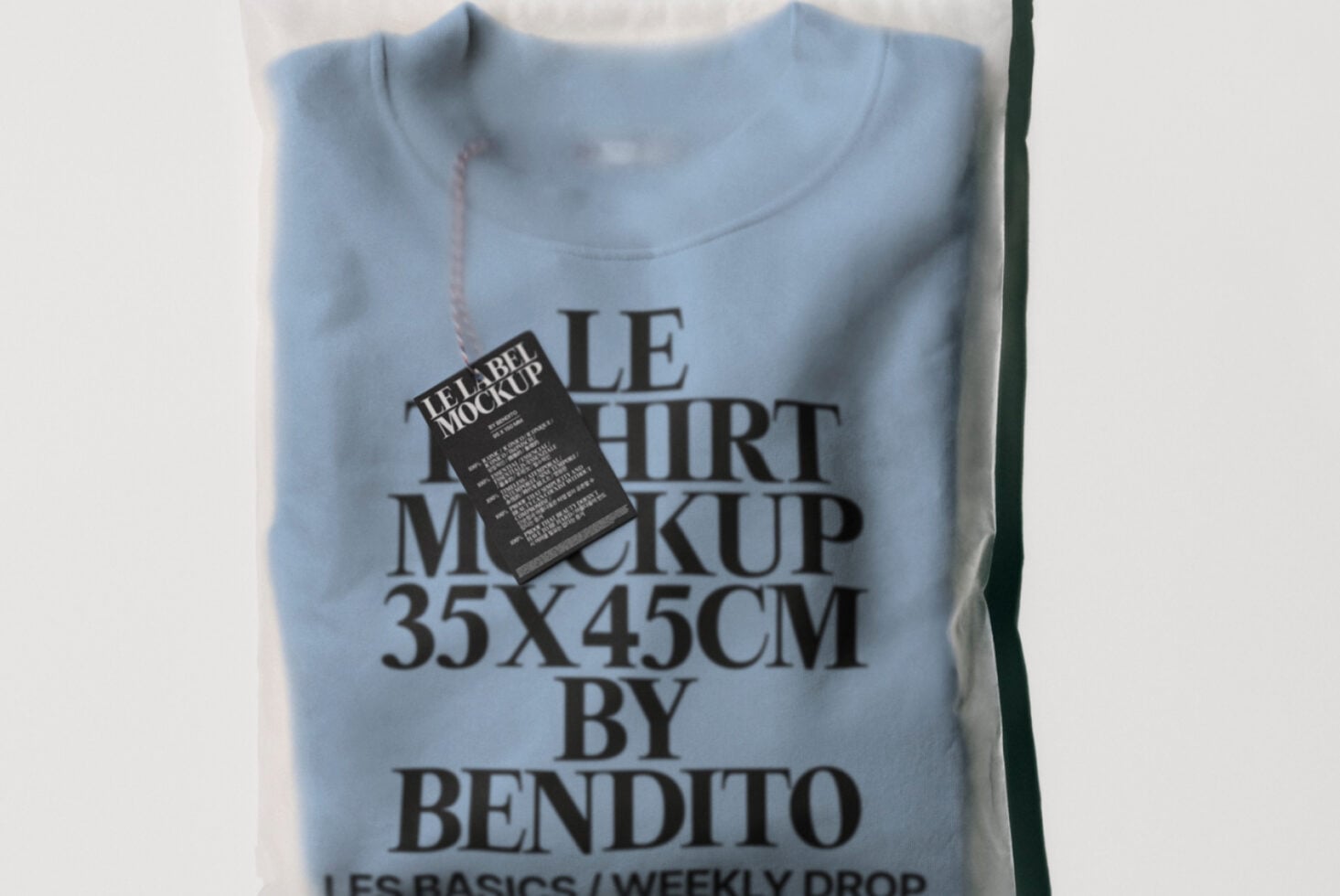 Light blue t-shirt flat lay with motel-style keychain label attached