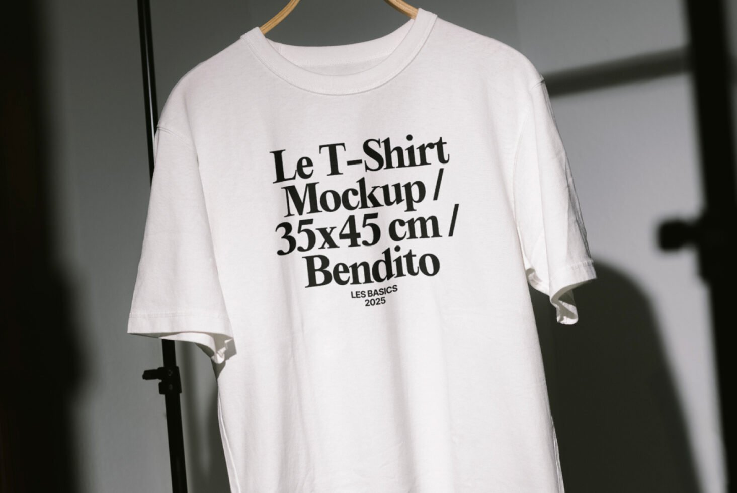 White t-shirt mockup on hanger with bold text detail for graphic design projects and apparel presentations. Perfect for designers seeking templates.