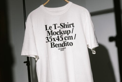 White t-shirt mockup on hanger with bold text detail for graphic design projects and apparel presentations. Perfect for designers seeking templates.