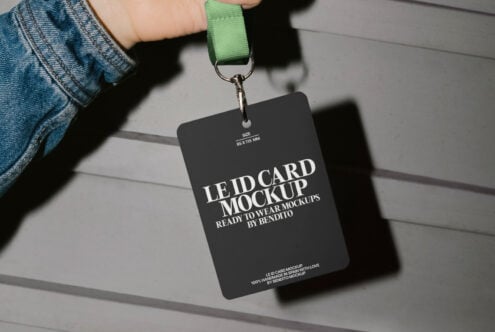 Hand holding ID card mockup with green lanyard. Ideal for designers seeking professional identity card templates. Realistic presentation great for branding.