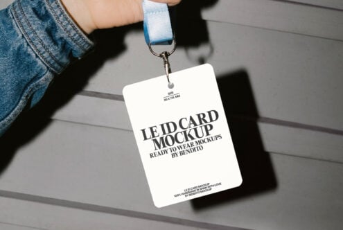 Hand holding ID card mockup with blue lanyard. Ideal for design projects, identity branding, and template creation. High-quality mockups for designers.