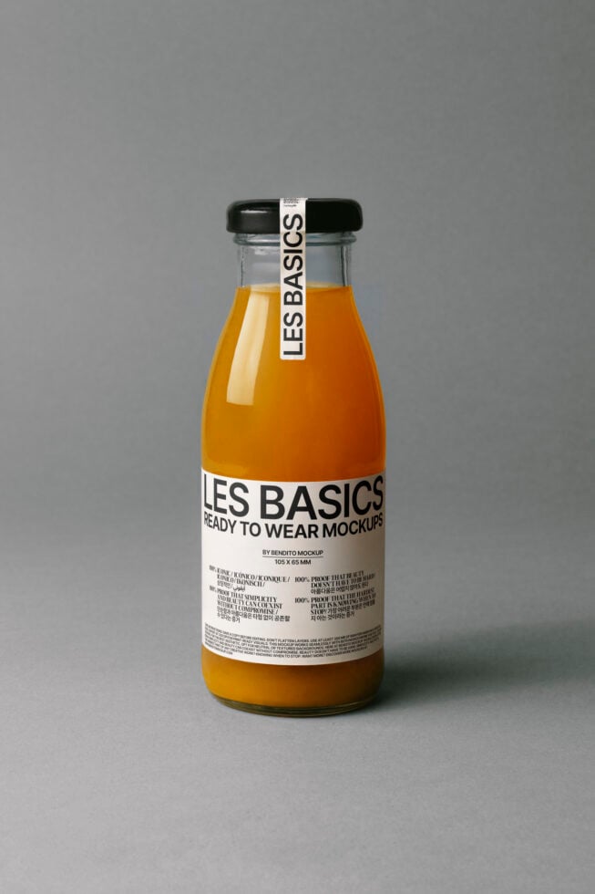 Glass bottle with black cap displaying Les Basics label. Ideal for branding and packaging design mockups for showcasing product labels.