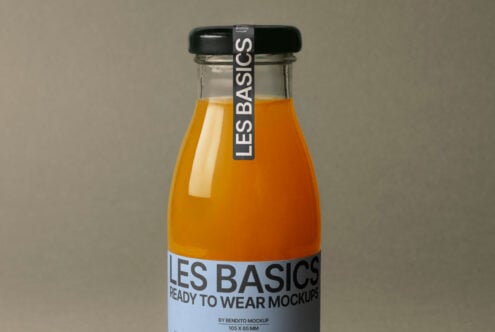 Orange juice bottle mockup with black cap and blue label reading Les Basics on a neutral background. Perfect for packaging designs and branding templates.