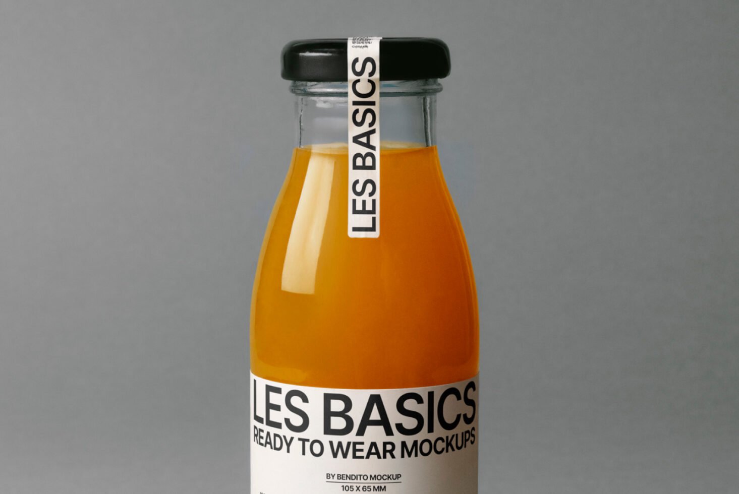 Glass bottle mockup with orange liquid and minimalist label on gray background ideal for product packaging design presentation and branding mockups.