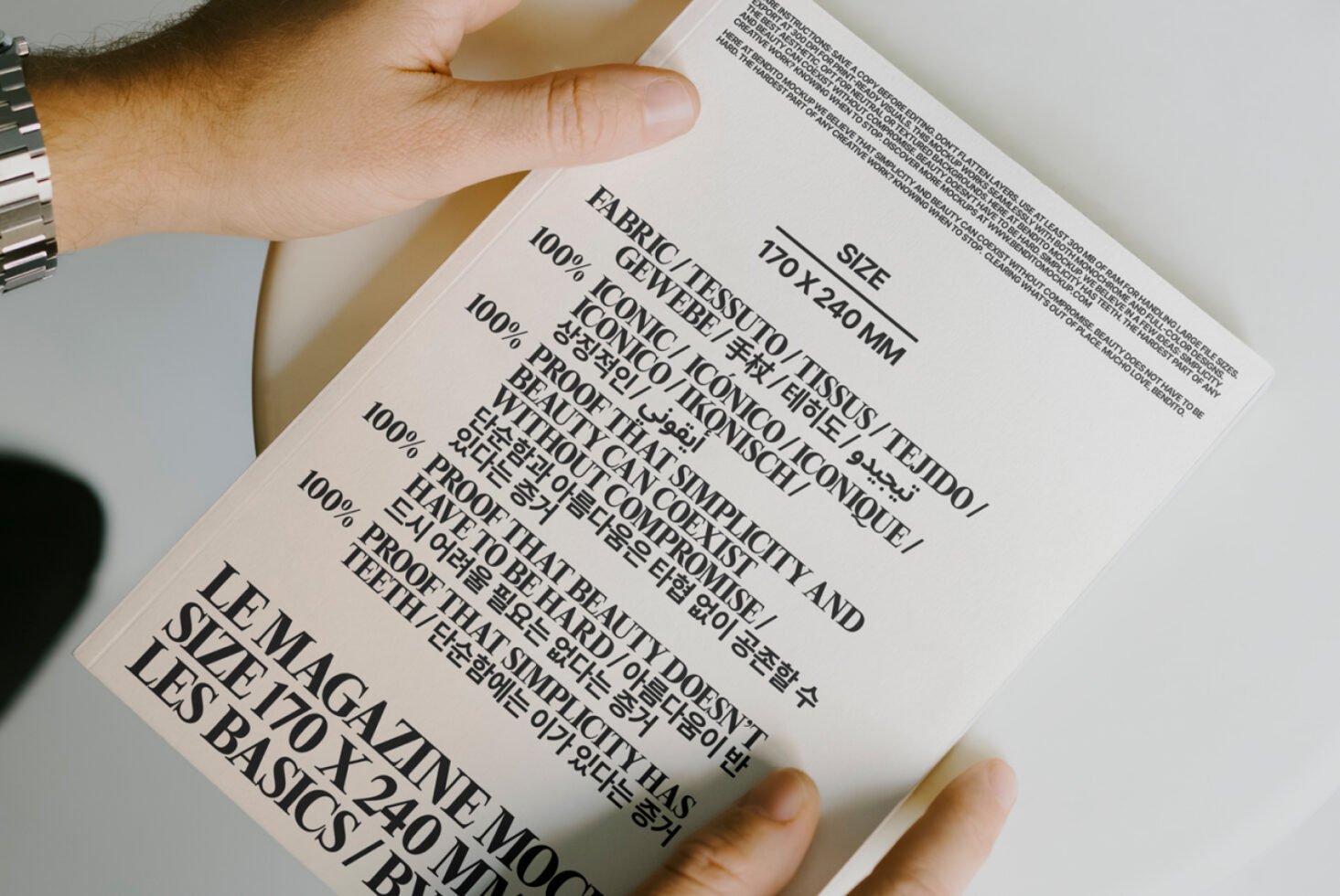 Magazine mockup featuring bold typography and multilingual text on a white cover. Ideal for designers focusing on fonts and editorial templates.