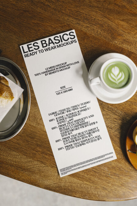 Menu card mockup on wooden table with coffee and pastry. Printable template for designers. Use for graphic design projects. Realistic presentation.