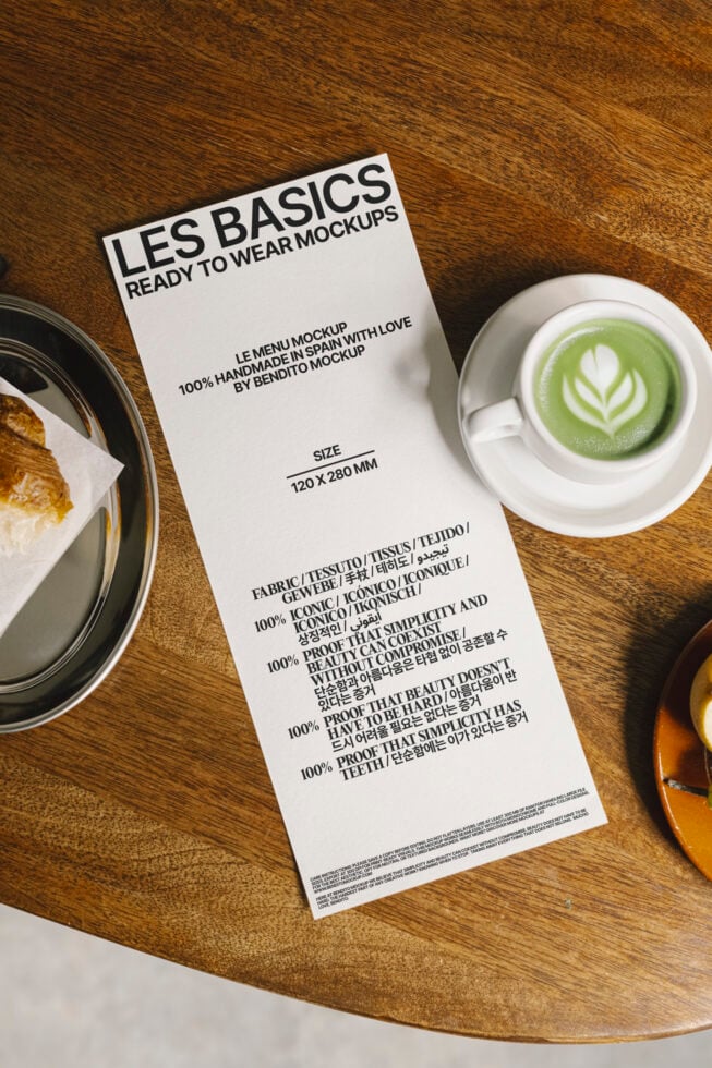 Menu card mockup on wooden table with coffee and pastry. Printable template for designers. Use for graphic design projects. Realistic presentation.
