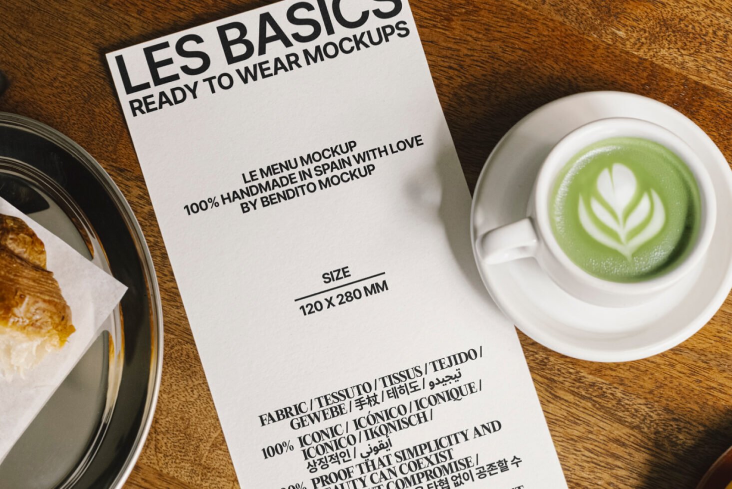 Menu mockup on wooden table with cup of matcha latte and croissant on plate ideal for designers branding graphics mockups print templates SEO