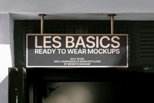 Outdoor storefront sign mockup displaying Les Basics ready to wear typography. Ideal for showcasing branding designs. Premium mockup for designers.