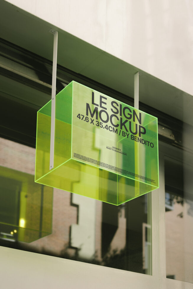 Green glass sign mockup hanging on a building facade. Perfect for urban branding presentations. Keywords: mockup, signage, template, design resource.