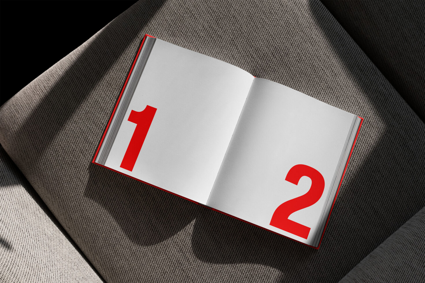 Open book mockup on a textured gray surface displaying large red numbers. Perfect for digital templates and graphic design assets for designers.