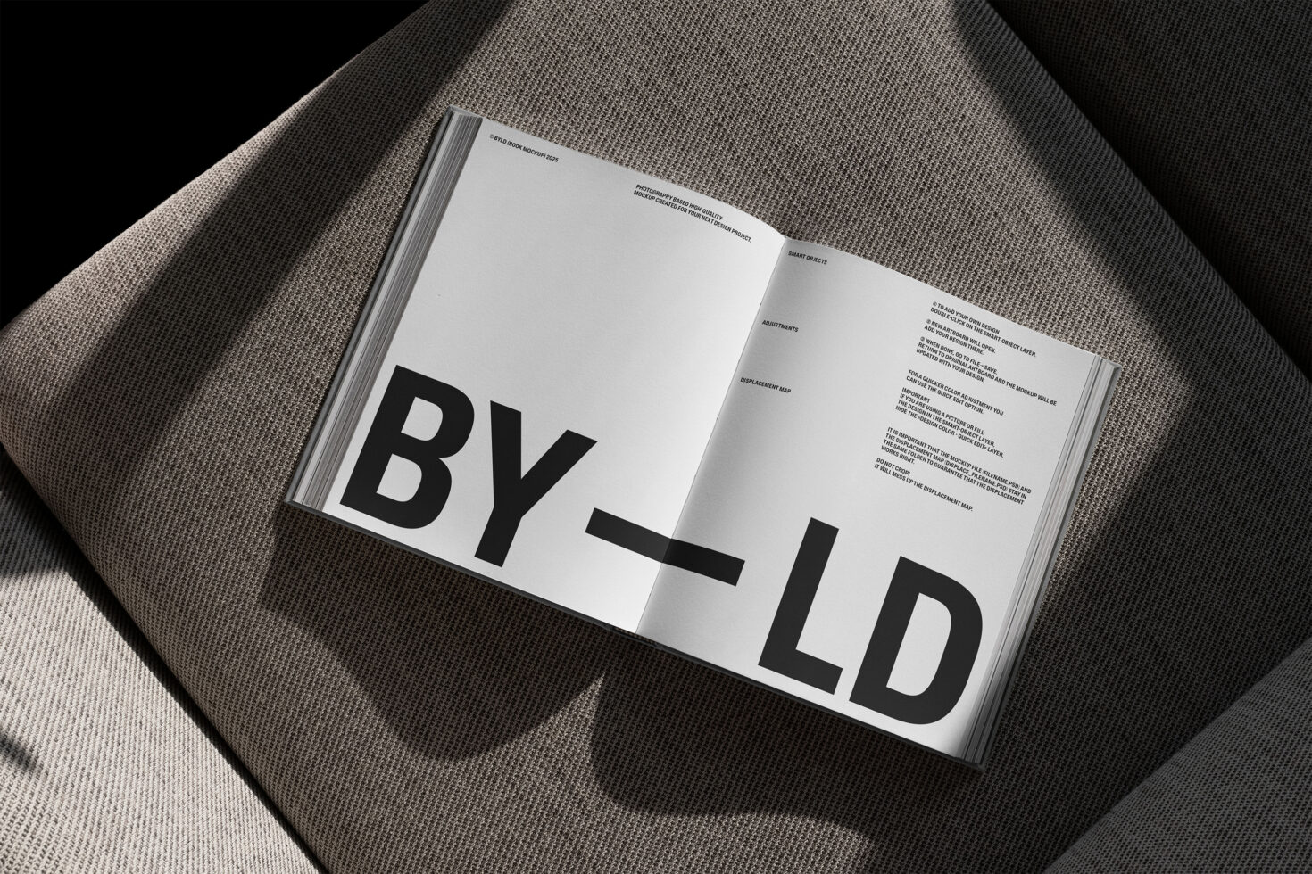 Open magazine mockup on gray fabric background showcasing bold typography design perfect for showcasing templates or graphics for designers.