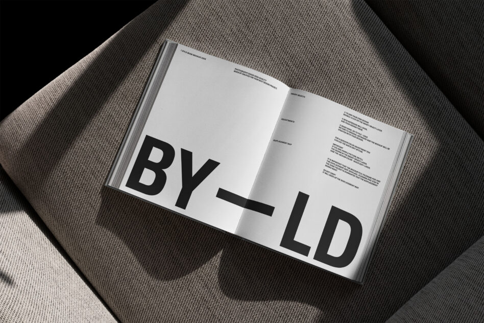 Open interior spread of book displaying BY_LD text with small type on pages