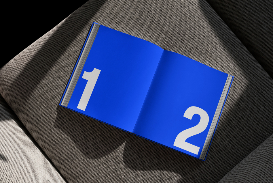 Open blue hardcover book with cream numerals 1 on left page, 2 on right side