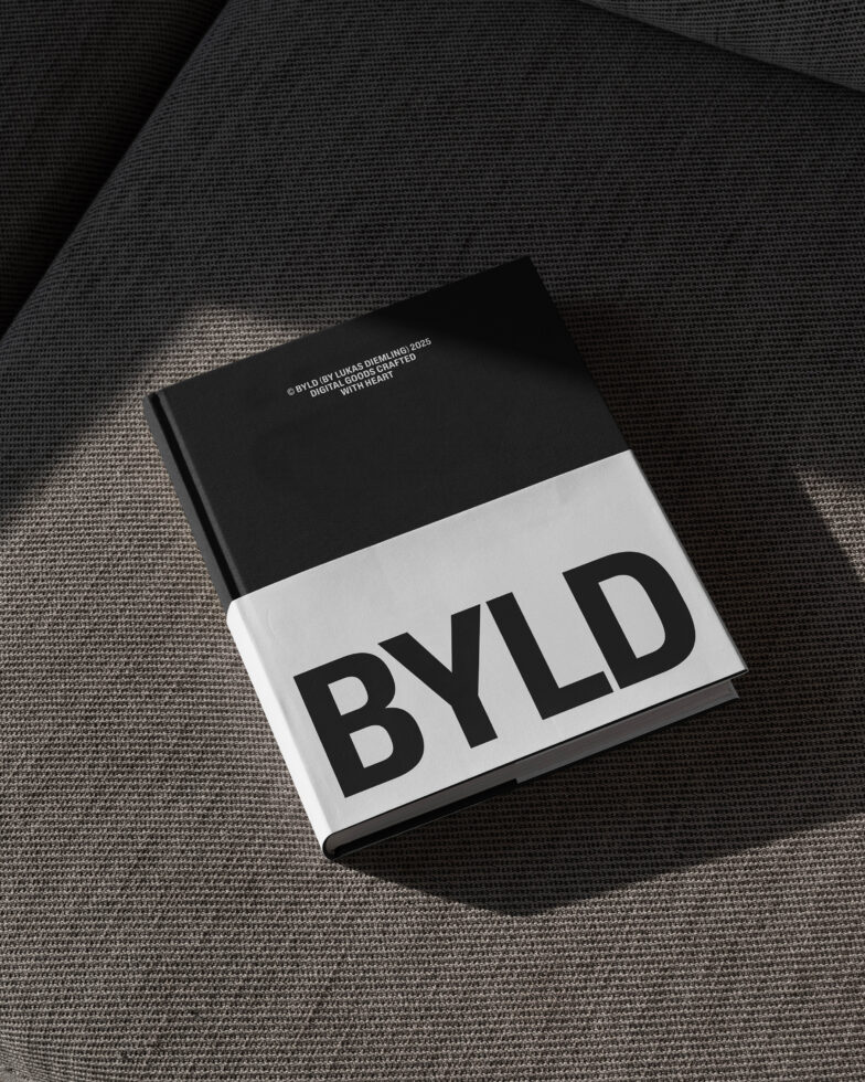 Hardcover book mockup titled BYLD on textured fabric background. Minimalist design for graphic designers marketing digital assets. Office setting.