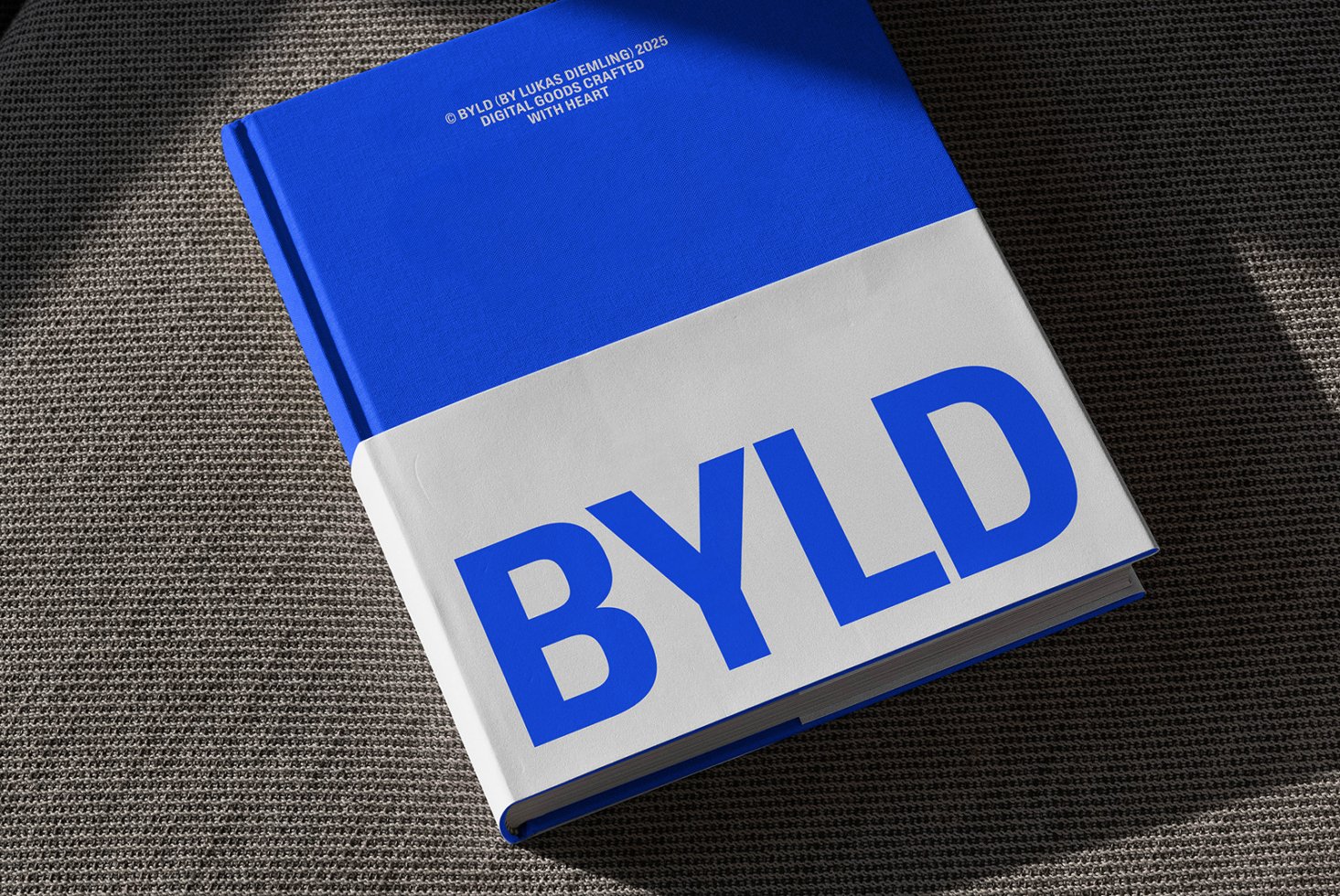 Blue and white hardcover book mockup on textured grey background. Ideal for showcasing branding, typography, and design templates for creatives.