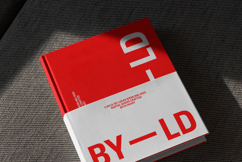 Red hardcover book with white lowercase 'by ld' split across cream section