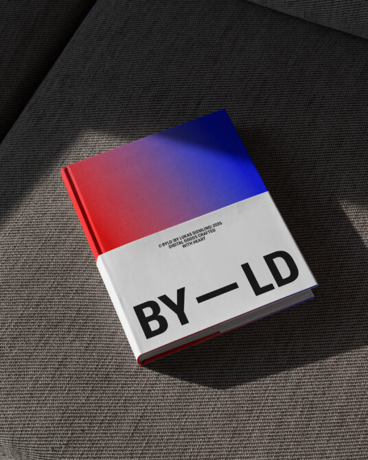 Gradient red to blue hardcover with dark BYLD text on linen
