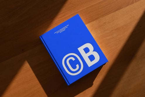 Blue hardcover mockup template on wooden surface showcasing bold typography design ideal for graphic designers digital assets marketplace SEO keywords