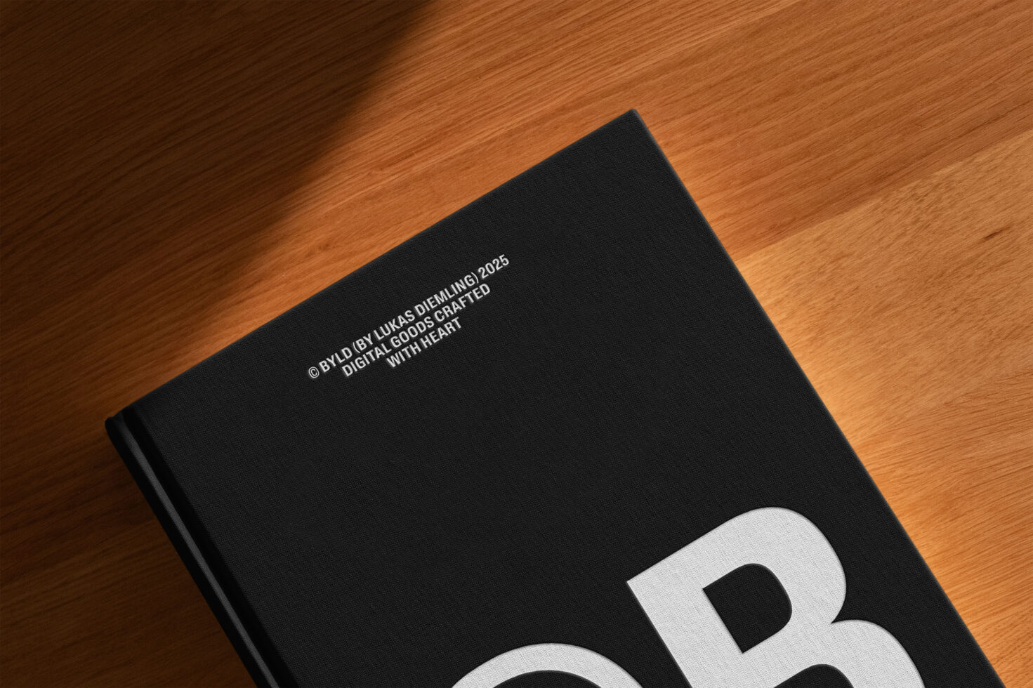Black hardcover book mockup on wooden surface perfect for designers features bold typography Digital assets crafted with heart for creative projects