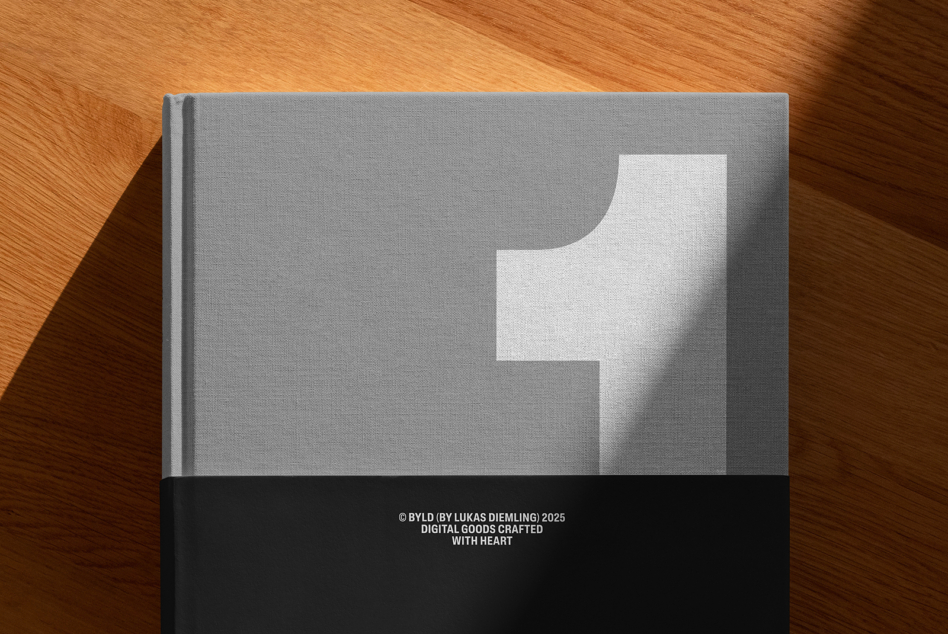 Minimalist hardcover book with white abstract shape on wood table